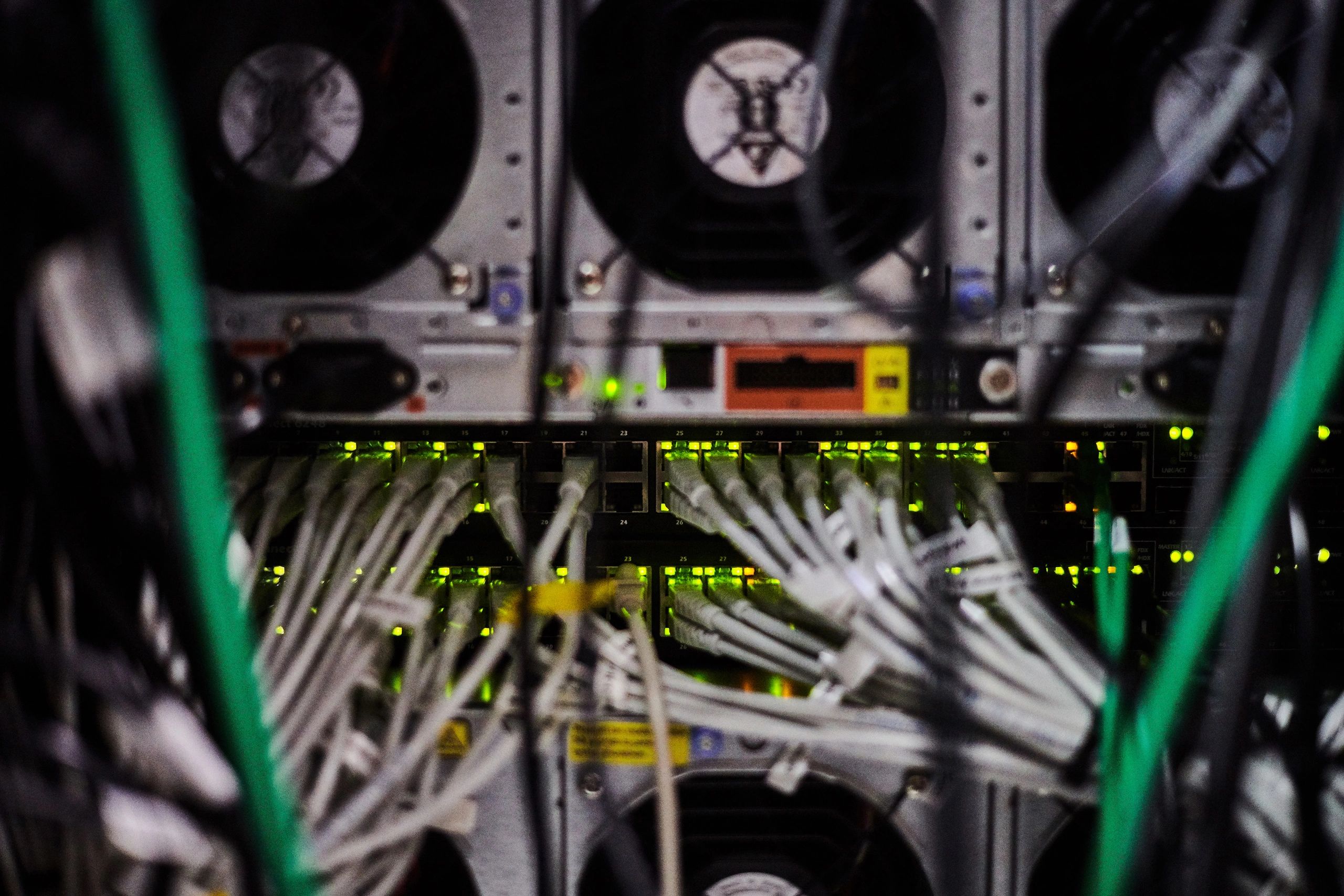 Server room equipment with organized cabling and status LEDs